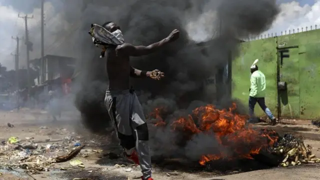 A supporter of the opposition Azimio coalition throws stones towards police (not pictured) during a nationwide protest in Nairobi, Kenya