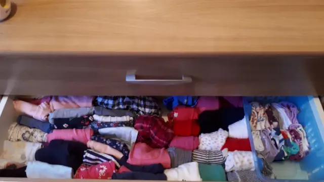 A draw of clothes folded in the Marie Kondo style