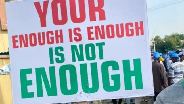 Protest banner wey say enough is enough