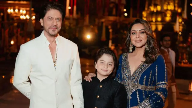 Shah Rukh Khan, a mulher, Gauri, e o filho, AbRam, posando para foto durante um dos eventos