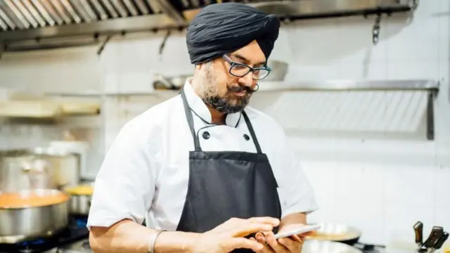 ਮੋਬਾਈਨ ਦੇਖ ਰਿਹਾ ਸਿੱਖ ਖਾਨਸਾਮਾ