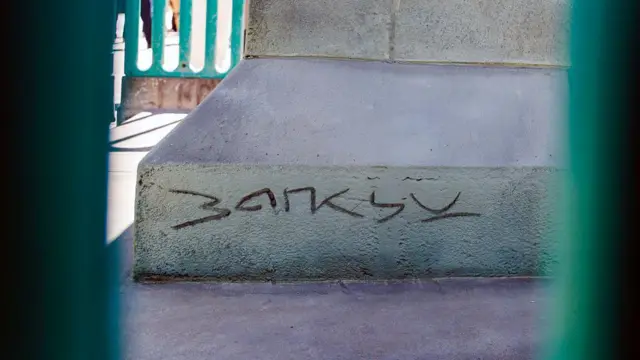 La firma de Banksy grabada en el zócalo de la estatua. 