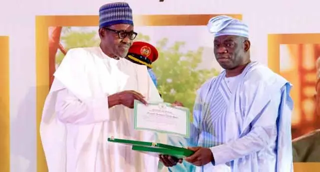 M.K.O Abiola's son, Kola receiving a post humous GCFR award from President Buhari on June 12, 2018.