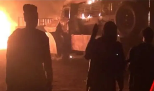 Three people at an explosion site