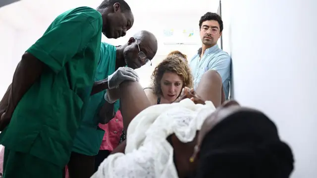 France obstetrician-gynaecologist Sarah Abramowicz and France obstetrician-gynaecologist Flavio Tonini (R), surrounded by Chad obstetrician Constant Naim (L) and Togo obstetrician Baguilane Douaguibe, examine a patient for 2025
