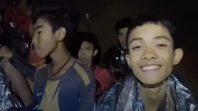 Duangpetch "Dom" Promthep (right) filmed by rescuers in the cave