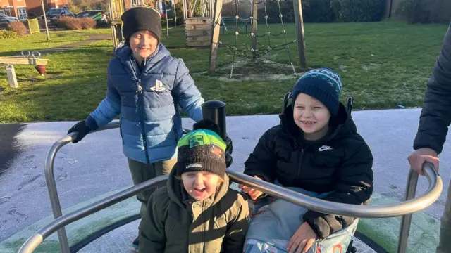 Rupert en una rotonda accesible con sus dos hermanos