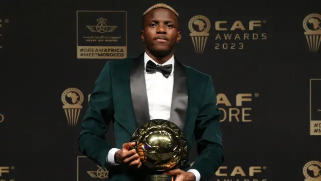 Victor Osimhen with the Confederation of African Football's men's player of the year award in December 2023