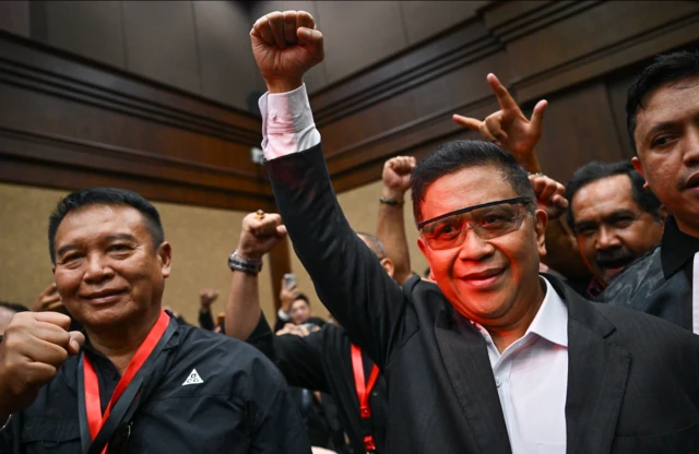 Terdakwa kasus dugaan suap pergantian antarwaktu (PAW) untuk anggota DPR Harun Masiku dan perintangan penyidikan, Hasto Kristiyanto (tengah) mengepalkan tangan sebelum menjalani sidang vonis di Pengadilan Tipikor, Jakarta, Jumat (25/7/2025). 