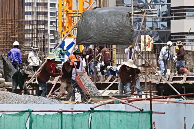Workers pour cement at a building construction site in Bangkok on May 10, 2020. (Photo by Romeo GACAD / AFP) (Photo by ROMEO GACAD/AFP via Getty Images)