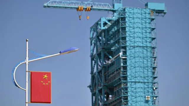 Ракета-носитель Long March-2F с космическим кораблем «Шэньчжоу-20» в строительных лесах на стартовой площадке за день до запуска корабля «Шэньчжоу-20» в Центре запуска спутников Цзюцюань в пустыне Гоби на северо-западе Китая