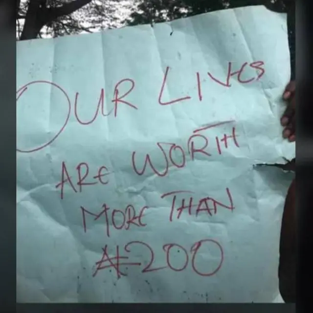 Students carry placard
