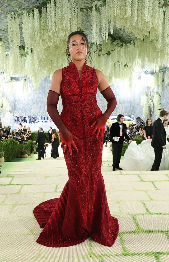 Naomi Osaka reveal red dress underneath her coat.