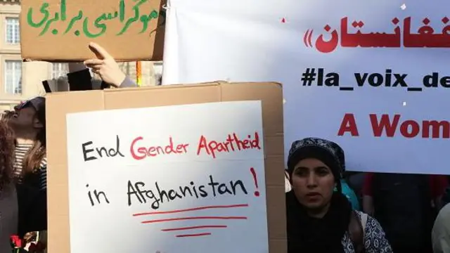 پاریس، فرانسه - ۸ مارس: یک زن مسلمان در یک تجمع مقاومت به مناسبت روز جهانی زن در ۸ مارس ۲۰۲۵ در پاریس، فرانسه، پلاکاردی در دست دارد که روی آن نوشته شده است: «به آپارتاید جنسیتی در افغانستان پایان دهید!».