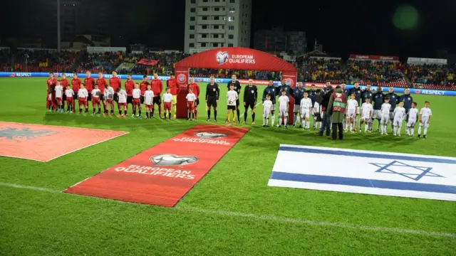 Albania's and Israel's national teams are seen during the anthem singing ceremony prior to the World Cup 2018 qualifier football match between Albania and Israel at the Elbasan Arena stadium in Elbasan, Albania on November 11, 2016.