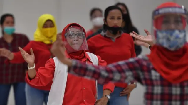 Sejumlah ibu melakukan senam lantai dengan menerapkan protokol kesehatan COVID-19 di salah satu pusat perbelanjaan di Surabaya, Jawa Timur, Selasa (14/07)