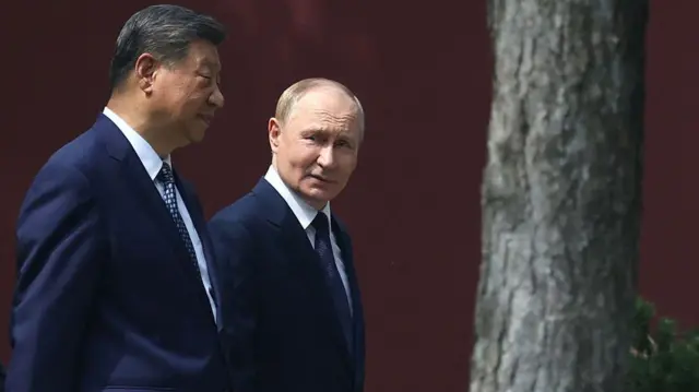In this pool photograph distributed by the Russian state agency Sputnik, Russia's President Vladimir Putin and China's President Xi Jinping walk at Zhongnanhai leadership compound in Beijing on September 2, 2025.