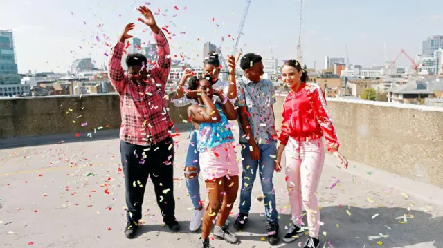 Teenagers having a rooftop party celebration.
