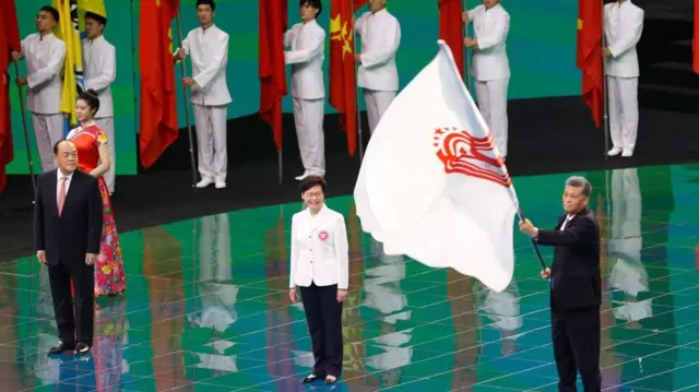 Macao Chief Executive Ho Iat-seng, Hong Kong Chief Executive Carrie Lam Cheng Yuet-ngor, and governor of Guangdong Province Ma Xingrui attend the flag handover ceremony during the closing ceremony of China's 14th National Games at Xi'an Olympic Sports Center on September 27, 2021 in Xi'an, Shaanxi Province of China