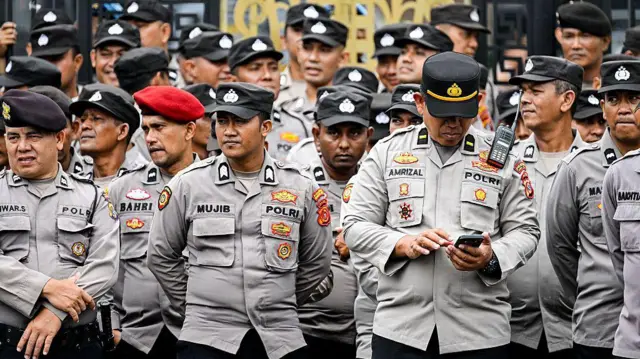 Polisi berjaga di depan gedung Dewan Perwakilan Rakyat Aceh (DPRA) di Banda Aceh pada 1 September 2025 saat terjadi protes mahasiswa yang menuntut reformasi kepolisian dan pembubaran parlemen.