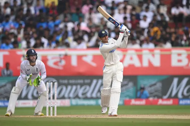 India batsman Shubman Gill hits a six watched by Ben Foakes during day three of the 2nd Test Match between India and England at ACA-VDCA Stadium on February 04, 2024 in Visakhapatnam, India. (Photo by Stu Forster/Getty Images)
