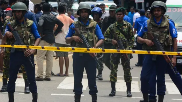 Sri Lankan military officers stand guard outside church after attack