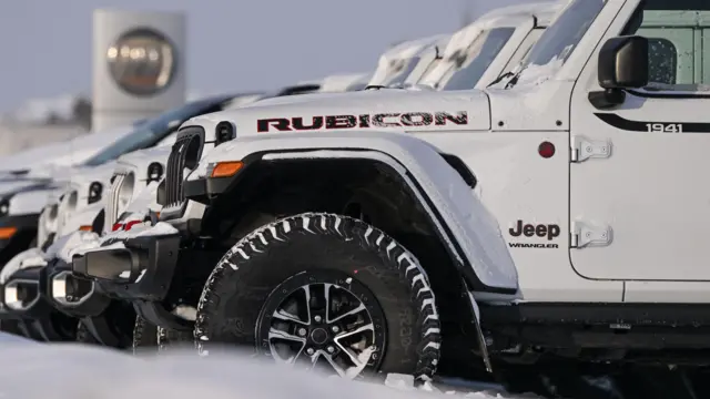 A row of Jeep Rubicons on a dealer's forecourt in the US