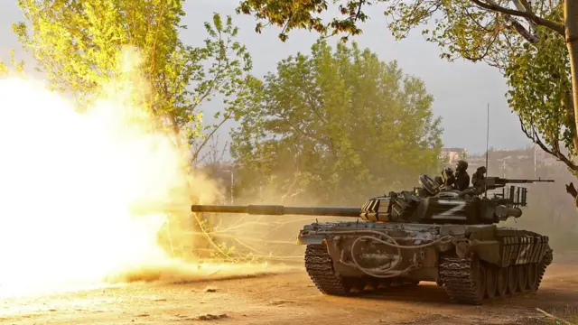 pro-russian forces fire from a tank in mariupol