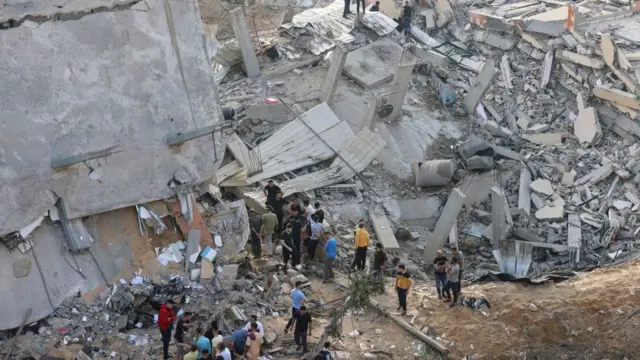 Palestinians check di damage inside di pieces building wey dem destroy on di first day of di Eid al-Fitr holiday.