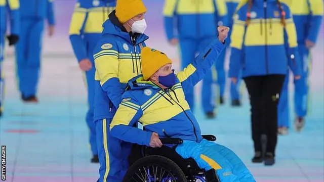 A member of the Ukrainian team raises his fist