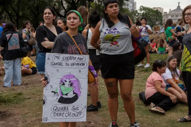A woman holds a sign during a demonstration called to commemorate the International Women's Day on 8 March 2024 in Buenos Aires, Argentina