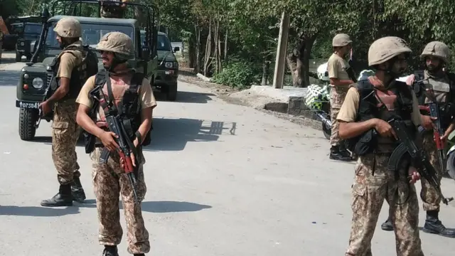 Pakistani soldiers cordon off a street leading to Christian colony following an attack by suicide bombers on the outskirts of Peshawar on September 2, 2016