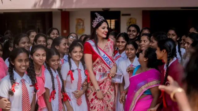 Former Mrs. World Caroline Jurie with school children
