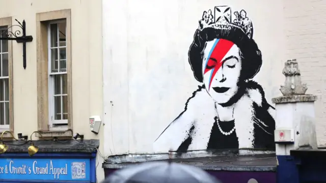 O muraltimes de futebolBanksytimes de futebolBristol, na Inglaterra, mostra a rainha Elizabeth 2ª vestida como na capa do álbum Aladdin Sane,times de futebolDavid Bowie,times de futebolhomenagem afetuosa