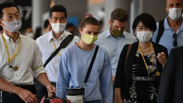 Krystsina Tsimanouskaya pictured with Japanese officials at Tokyo Airport