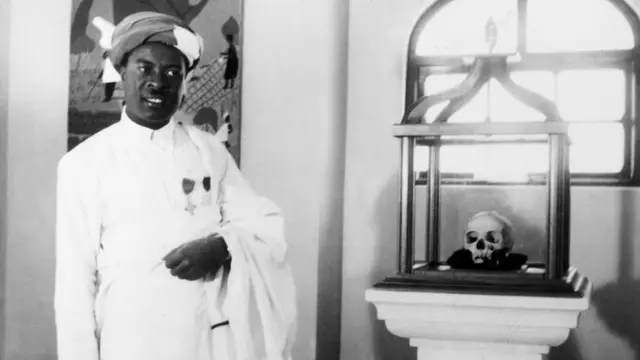 Chief Adam Sappi standing next to skull in a glass box