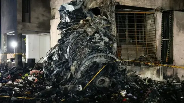 The wreckage of what looks like one of the plane engines ended up laying on the street near a gutted building 