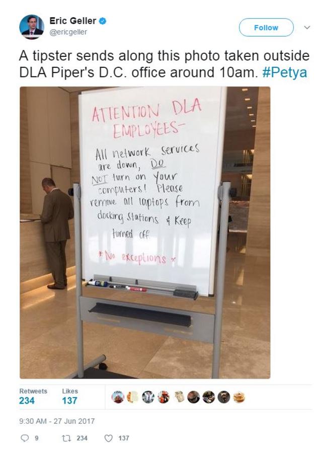 Tuit que muestra una pizarra en la que advierten a los empleados de la firma DLA que no enciendan sus computadores.