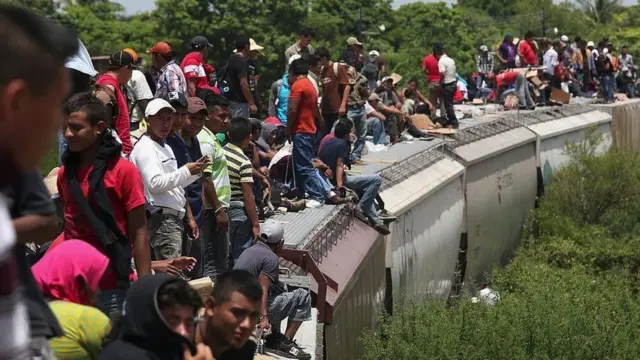 Migrants travelling on a train roof