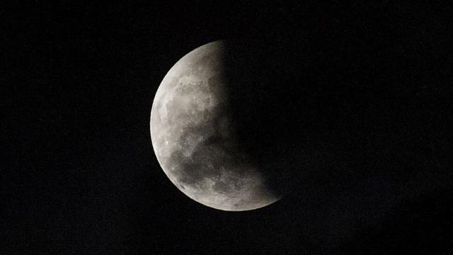 A lunar eclipse is partially seen from The Avenue of Stars in Hong Kong on October 8, 2014. The total lunar eclipse is the second of two in 2014 and the second in a tetrad (four total lunar eclipses in series).