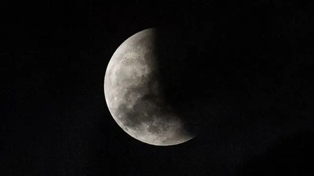 A lunar eclipse is partially seen from The Avenue of Stars in Hong Kong on October 8, 2014. The total lunar eclipse is the second of two in 2014 and the second in a tetrad (four total lunar eclipses in series).