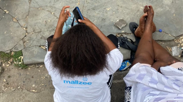 Madam Sandra siddown for front of di telecom officd