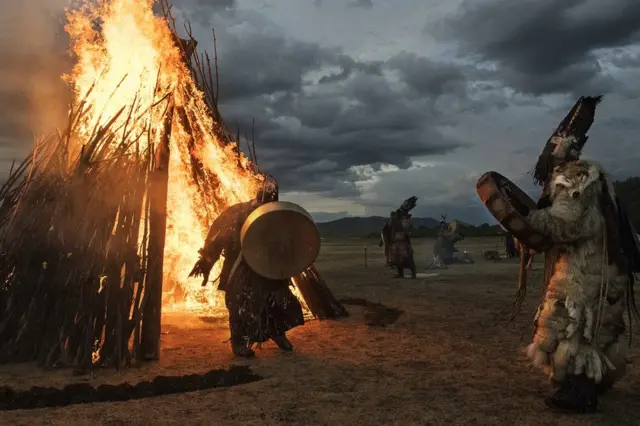 A shaman runs through fire