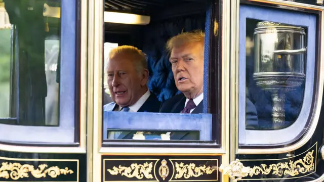  King Charles III and U.S. President Donald Trump inside carriage during di carriage procession during di State visit by di President of di United States of America at Windsor Castle for September 17, 2025 for Windsor, England. 
