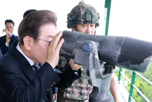 이재명 대통령이 13일 경기도 연천군 육군 25사단 비룡전망대에서 망원경으로 북측 지역을 보고 있다