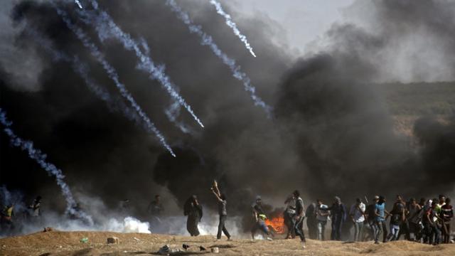 Tear gas is fired at protestors during clashes with Israeli forces near the border between the Gaza strip and Israel