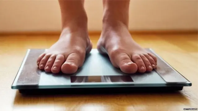 वजन करणाऱ्या व्यक्तीचे पाय
