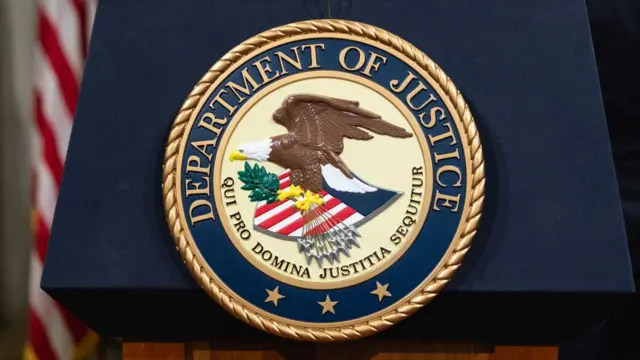 The Department of Justice seal is seen on a podium