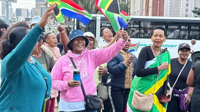 Anti-migrant protesters hold flag dey march against illegal migrants for South Africa