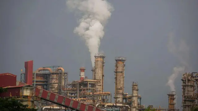 石油精製所の煙突が並び、空に向かって水蒸気が白煙となって上っている